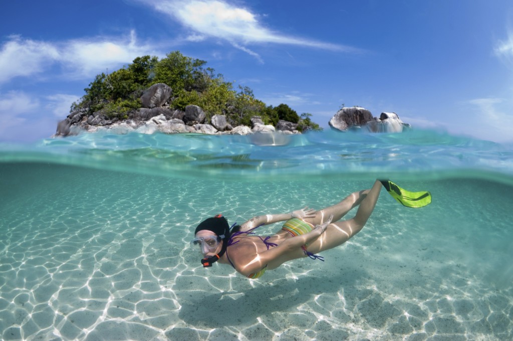 Woman-snorkeling-in-front-of-small-thailand-island-iStock_000014822643Large